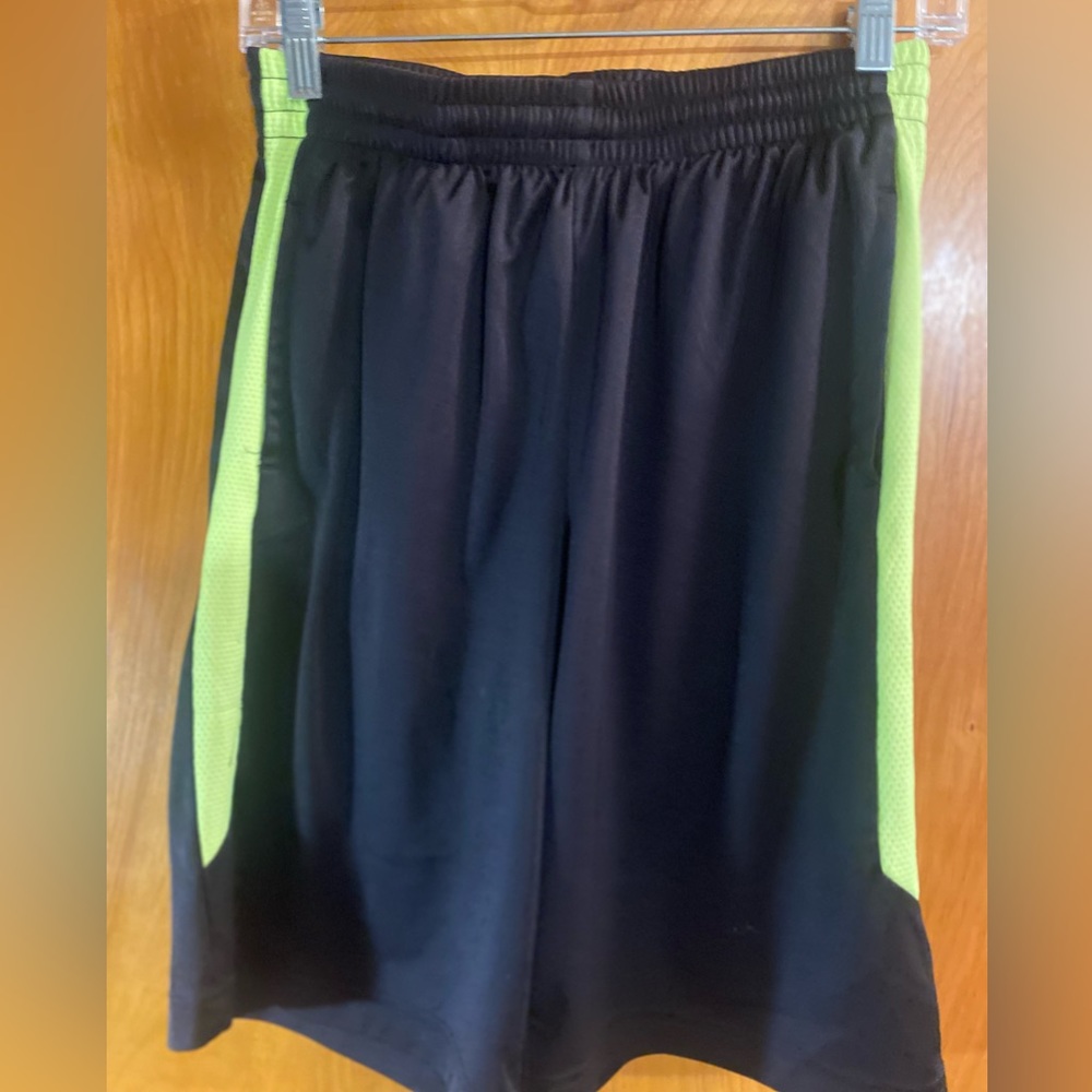Boys “TEG GEAR” black shorts with green stripes.